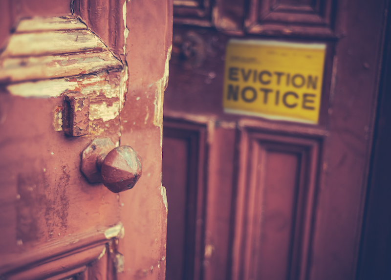 Grungy,Old,Door,With,A,Yellow,Eviction,Notice